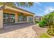 Enjoy outdoor living on this covered patio with brick pavers, ceiling fan, and desert landscaping at 1804 E Sattoo Way, Queen Creek, AZ 85140