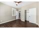Bedroom with hardwood floors, neutral walls, ceiling fan and large window with plantation shutters at 1804 E Sattoo Way, Queen Creek, AZ 85140
