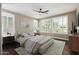 Cozy bedroom featuring natural light, ceiling fan, and modern decor for ultimate relaxation at 1804 E Sattoo Way, Queen Creek, AZ 85140