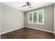 Bedroom with hardwood floors, neutral walls, ceiling fan and large window with plantation shutters at 1804 E Sattoo Way, Queen Creek, AZ 85140