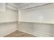 Walk in closet with wood-look tile floors and built in shelving at 1804 E Sattoo Way, Queen Creek, AZ 85140