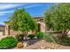Quaint home exterior showcasing desert landscaping, mature trees, and low maintenance yard at 1804 E Sattoo Way, Queen Creek, AZ 85140
