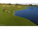 Scenic golf course view featuring lush green fairways, a tranquil lake, and manicured greens at 1804 E Sattoo Way, Queen Creek, AZ 85140