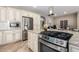 Gourmet kitchen featuring stainless appliances, granite counters, gas cooktop, and custom cabinetry at 1804 E Sattoo Way, Queen Creek, AZ 85140
