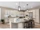 Spacious kitchen featuring island, granite counters, stainless appliances, breakfast bar, and custom cabinetry at 1804 E Sattoo Way, Queen Creek, AZ 85140