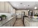 Gourmet kitchen with island, granite countertops, stainless steel appliances, and custom cabinets at 1804 E Sattoo Way, Queen Creek, AZ 85140