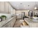 Bright kitchen with large island, granite countertops, stainless steel appliances, and custom cabinets at 1804 E Sattoo Way, Queen Creek, AZ 85140