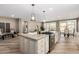 Open concept kitchen with island, granite countertops, stainless steel appliances, and breakfast nook at 1804 E Sattoo Way, Queen Creek, AZ 85140