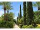 Serene pathway lined with lush trees and manicured shrubs, creating a peaceful ambiance at 1804 E Sattoo Way, Queen Creek, AZ 85140