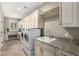 Spacious laundry room with granite countertops, ample cabinet space, and modern appliances at 1804 E Sattoo Way, Queen Creek, AZ 85140