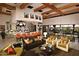 Spacious living room boasts a bar area, TV, hardwood floors and a wall of windows providing natural light at 1804 E Sattoo Way, Queen Creek, AZ 85140