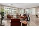 Bright living room with fireplace, wood floors, large windows, and natural light at 1804 E Sattoo Way, Queen Creek, AZ 85140