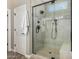 Elegant tile shower with frameless glass door, rain shower head and seating at 1804 E Sattoo Way, Queen Creek, AZ 85140