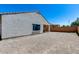 Exterior view of the backyard showing stucco home with a covered patio and ample space at 20142 N 260Th Dr, Buckeye, AZ 85396