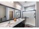 Bright bathroom with double sinks, modern fixtures, and a spacious glass-enclosed shower at 20142 N 260Th Dr, Buckeye, AZ 85396