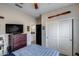 Comfortable bedroom features wood dresser with TV and neutral walls at 20142 N 260Th Dr, Buckeye, AZ 85396