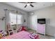 Bright pink bedroom with natural light and ceiling fan at 20142 N 260Th Dr, Buckeye, AZ 85396
