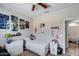 Neutral bedroom with ceiling fan, a window, and lots of decor at 20142 N 260Th Dr, Buckeye, AZ 85396