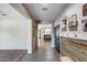 Inviting entryway featuring wood accents, decorative shelving, and neutral color palette at 20142 N 260Th Dr, Buckeye, AZ 85396