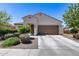 Charming single-story home with a well-maintained front yard and a two-car garage in a sunny neighborhood at 20142 N 260Th Dr, Buckeye, AZ 85396
