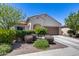 Charming single-story home with a well-maintained front yard and a two-car garage in a sunny neighborhood at 20142 N 260Th Dr, Buckeye, AZ 85396