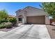 Charming single-story home with a well-maintained front yard and a two-car garage in a sunny neighborhood at 20142 N 260Th Dr, Buckeye, AZ 85396