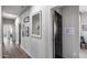 Hallway featuring neutral walls, wood floors, decorative mirrors, and dark trim doors at 20142 N 260Th Dr, Buckeye, AZ 85396