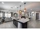 Spacious kitchen with island and bar stool seating, stainless appliances, and a view into the living room at 20142 N 260Th Dr, Buckeye, AZ 85396