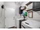 Bright laundry room with modern washer and dryer, shelving, and decorative accents at 20142 N 260Th Dr, Buckeye, AZ 85396