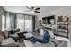 Comfortable living room showcasing a large sectional sofa, decorative pillows, a ceiling fan, and a modern entertainment center at 20142 N 260Th Dr, Buckeye, AZ 85396