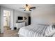 Cozy main bedroom featuring a ceiling fan, gray walls, and an ensuite bath entrance at 20142 N 260Th Dr, Buckeye, AZ 85396