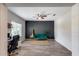 A home office space featuring hardwood floors, dark accent wall, and functional furniture at 20142 N 260Th Dr, Buckeye, AZ 85396