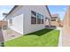 Exterior shot reveals a home featuring an artificial turf yard and a covered patio at 20308 W Roma Ave, Buckeye, AZ 85396