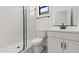 Modern bathroom with glass enclosed shower, subway tile, black fixtures and white cabinets at 20308 W Roma Ave, Buckeye, AZ 85396