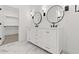 Bathroom boasts double sink vanity with modern fixtures, lighting and marbled floors at 20308 W Roma Ave, Buckeye, AZ 85396