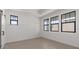 Bright bedroom features wood-look tile floor, white walls and trim, and black-trimmed windows for modern elegance at 20308 W Roma Ave, Buckeye, AZ 85396