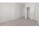 White bedroom with light carpet, white baseboards, closet and an open door at 20308 W Roma Ave, Buckeye, AZ 85396