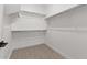Walk-in closet with wood-style tile flooring and white shelving at 20308 W Roma Ave, Buckeye, AZ 85396