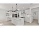 Spacious kitchen with white cabinets, a large island and stainless steel appliances at 20308 W Roma Ave, Buckeye, AZ 85396