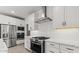 Bright kitchen featuring white cabinets, stainless steel appliances and subway tile backsplash at 20308 W Roma Ave, Buckeye, AZ 85396