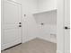 Laundry room with wood-look tile flooring and white shelving at 20308 W Roma Ave, Buckeye, AZ 85396