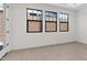 Living room with three black-trimmed windows at 20308 W Roma Ave, Buckeye, AZ 85396