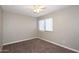 This cozy bedroom features neutral walls, plush carpeting, and a window for natural light, creating a comfortable space at 2040 S Longmore St # 7, Mesa, AZ 85202