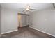 Spacious bedroom with neutral walls, ceiling fan, carpet, and view to closet and bathroom at 2040 S Longmore St # 7, Mesa, AZ 85202