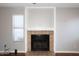 Close up of the living room fireplace featuring tan brick and a decorative mantle at 2040 S Longmore St # 7, Mesa, AZ 85202