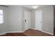 Condo foyer with tile flooring, neutral paint and two doors, one leading to an upstairs bedroom at 2040 S Longmore St # 7, Mesa, AZ 85202