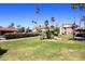 Well-maintained community grounds with lawn, desert landscaping, and palm trees at 2040 S Longmore St # 7, Mesa, AZ 85202