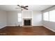 Bright and spacious living room featuring hard wood floors, a fan and a cozy fireplace at 2040 S Longmore St # 7, Mesa, AZ 85202