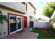 Cozy condo patio with sliding glass doors, red brick trim and a small fenced in yard at 2040 S Longmore St # 7, Mesa, AZ 85202
