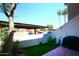 View from condo patio featuring covered parking, landscaping and an artificial turf area at 2040 S Longmore St # 7, Mesa, AZ 85202